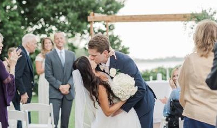 Bride and groom kissing at the end of their ceremony